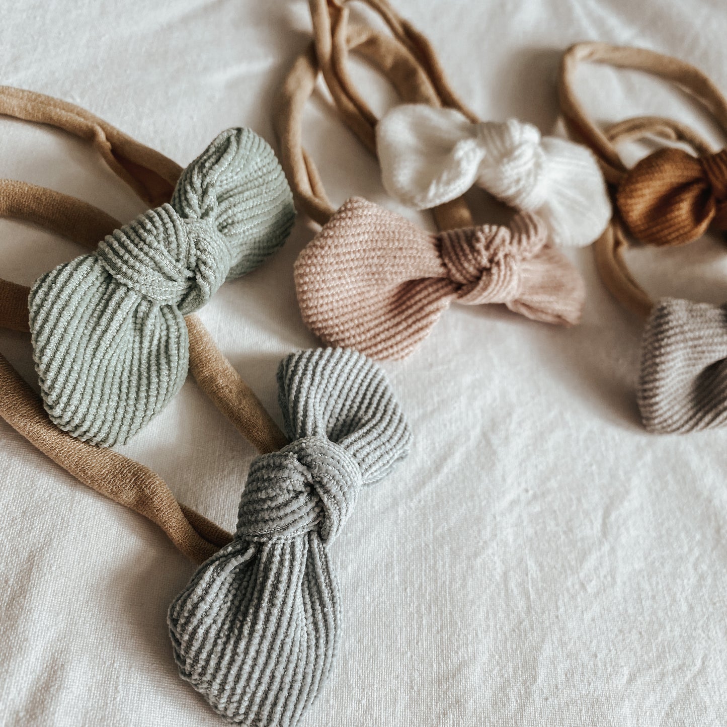 corduroy bow headband for baby girls. baby bows all sizes. adjustable. neutral colours and baby fashion accessories.